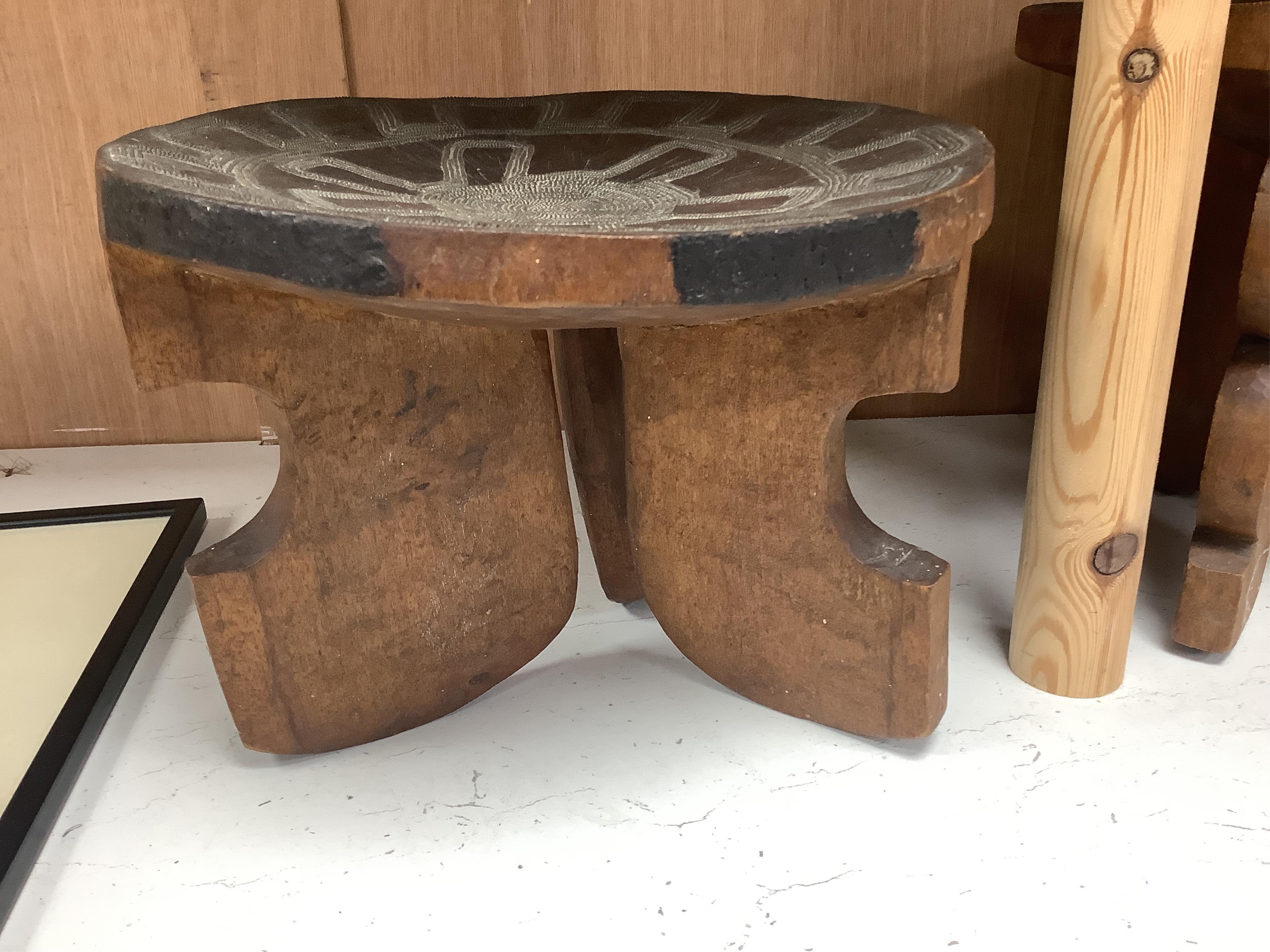 Two African tribal busts, two carved spoons and three carved Kamba Kenyan stools (11). Largest stool 28cm high. Condition - mostly good, some staining to seat of largest stool